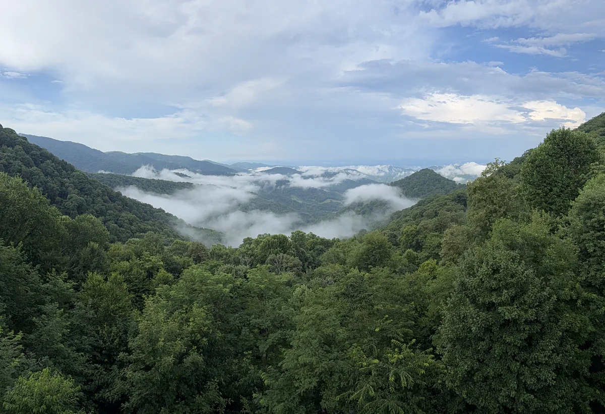 Bright summer clouds over green mountain ridges in Buncombe County